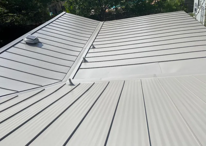 Solar attic fan installed on a metal roof for Roof Ventilation in Dorr